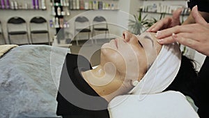 Face massage. Spa skin and body care. Close-up of young woman getting spa massage treatment at beauty spa salon. Facial
