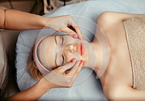 Face massage on woman in the spa salon