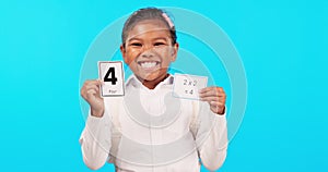 Face, math education and girl with cards in studio isolated on a blue background. Learning, multiplication and portrait