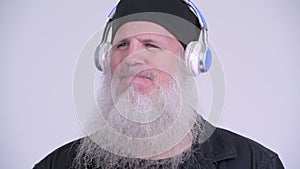 Face of mature bearded hipster man listening to music
