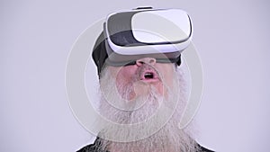 Face of mature bearded hipster man using virtual reality headset