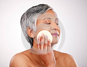 Face, mature woman and beauty pad for anti aging routine, skincare and remove makeup, foundation or product. Bathroom