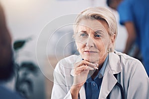 Face of mature woman, doctor and listening in consultation for healthcare support, communication and clinic services