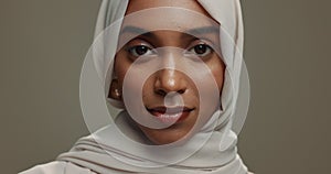 Face, muslim or happy woman in hijab on studio background for natural beauty, fashion or arabic culture in Saudi Arabia