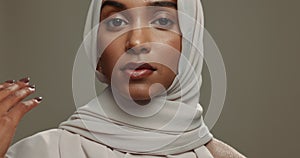 Face, muslim hijab or woman on studio background for beauty, fashion or arabic culture in Saudi Arabia. Serious portrait