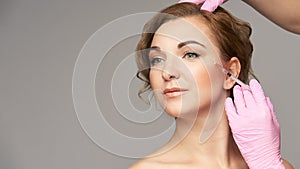 Face needle injection. Young woman cosmetology procedure. Doctor gloves. Wrinkles