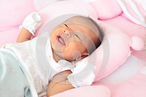 Face New born infant lied on pink bed