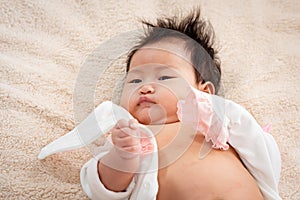 Face of newborn baby close up lying on the brown bed The little boy`s eyes stared nervously at something. The boy`s eyes were