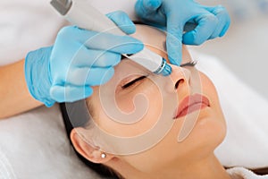 Face of a nice good looking woman during hydrafacial
