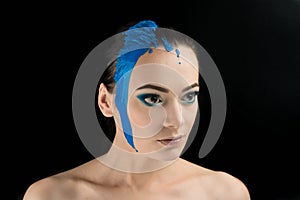Face paint makeup. creative makeover. the blue color on the face