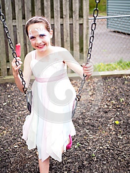 Face painted Young Girl on Swing