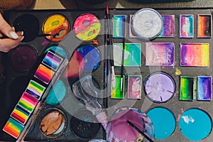 Face painting colors and tools of face painting artist. Concept photo artwork, art and craft.