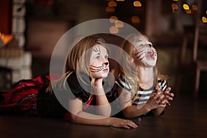 Face painting girls cats dark background, concept of holiday dar