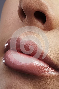 Face part. Beautiful female lips with natural makeup, clean skin. Macro shot of female lip, clean skin. Fresh kiss. Spa beauty cos