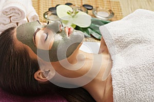 Face peeling mask, spa beauty treatment, skincare. Woman getting facial care by beautician at spa salon,  close-up.Spa clay mask o