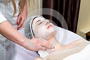 Face peeling mask, spa beauty treatment, skincare. Woman getting facial care by beautician at spa salon. Spa, resort, beauty and