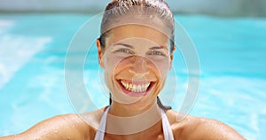 Face, pool and woman with a smile, summer and happiness with sunshine and vacation with getaway trip. Portrait, person