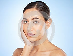 Face portrait, beauty skincare and woman in studio isolated on a blue background. Makeup, natural cosmetics and young