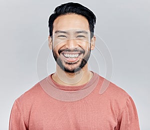 Face portrait, smile and happy Asian man in studio isolated on a white background or backdrop. Funny, fashion and young