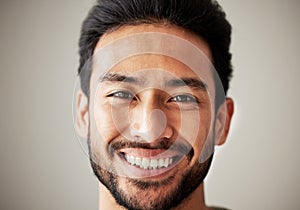 Face, portrait and smile of happy asian man in studio with positive mindset, wellness and awareness. Face of a young