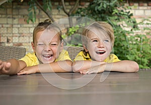 face portrait of two cute laughing boy 5 years old