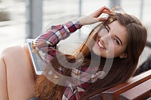 Face portrait of young woman using a tablet pc