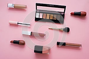 Face powder, brush and various cosmetic decorative makeup products on a color background. Close up. Makeup brush and