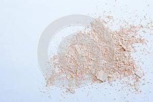 Face powder stroke isolated on white background. Make up. Beauty textures .Cosmetic background for beauty, fashion blog. Crumbling