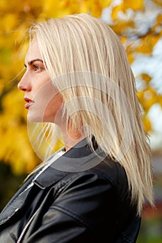 Face in profile of beautiful caucasian blond woman outdoors