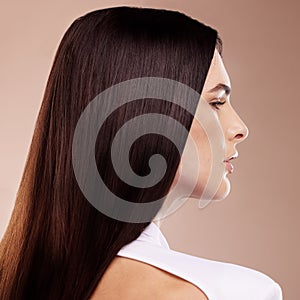 Face profile, beauty and hair care of woman in studio isolated on a brown background. Balayage, hairstyle and young