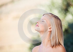 Face, profile and beauty of a woman outdoor in nature for natural makeup, dermatology or cosmetic. Person smelling air