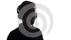 Face profile silhouette of music lover teenager listening to favorite song in headphones , handsome young man on white 