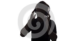 Face profile silhouette of music lover teenager listening to favorite song in headphones , handsome young man on white 