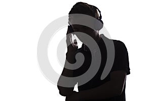 Face profile silhouette of music lover teenager listening to favorite song in headphones , handsome young man on white 