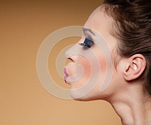 Face profile of young woman funny teen girl on brown