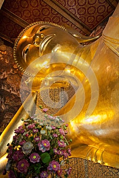 Face of Reclining Buddha gold statue in Bangkok, Thailand