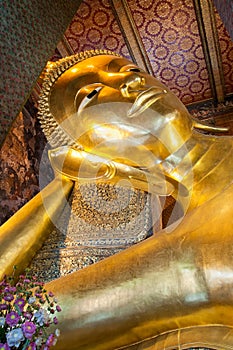 Face of Reclining Buddha gold statue in Wat Pho buddhist temple