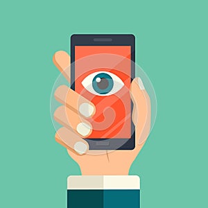 Face recognition, surveillance concepts. Hand holding smartphone with watching eye on screen. Mobile phone with eye icon. Modern f