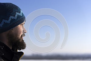 Face of Scandinavian bearded man in profile. Bearded looking into the distance. Close-up