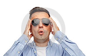 Face of scared man in shirt and sunglasses
