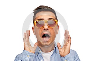 Face of scared man in shirt and sunglasses