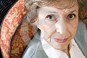 Face of serious elderly woman staring at camera