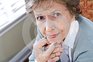 Face of serious elderly woman staring at camera