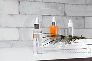 Face serum bottle on table at home bathroom. Minimal style. Beauty blogging, skin care ad mock up, copy space