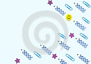 Face shaped yellow magnet, blue clips, pencil and star shaped paper stickers on white background. School and office supplies,