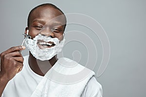 Face Shaving. Skincare Beauty Concept. Man Removes Facial Hair. Using Of Razor Shaver For Beard. photo