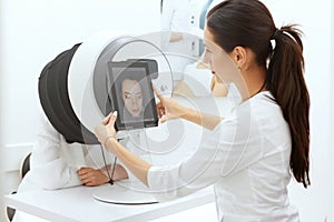 Face Skin Analysis. Woman At Cosmetology Doing Skin Diagnostic