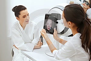 Face Skin Analyze. Cosmetologist Analyzing Woman Facial Skin