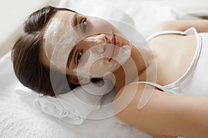 Face Skin Care. Beautiful Woman With Facial Cosmetic Mask At Spa