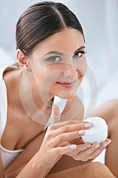 Face Skin Care. Beautiful Woman With Facial Cream. Cosmetics